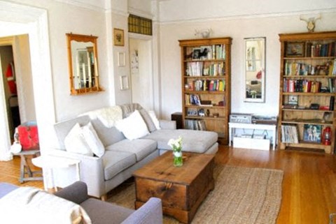 A living room with a white couch and a coffee table.